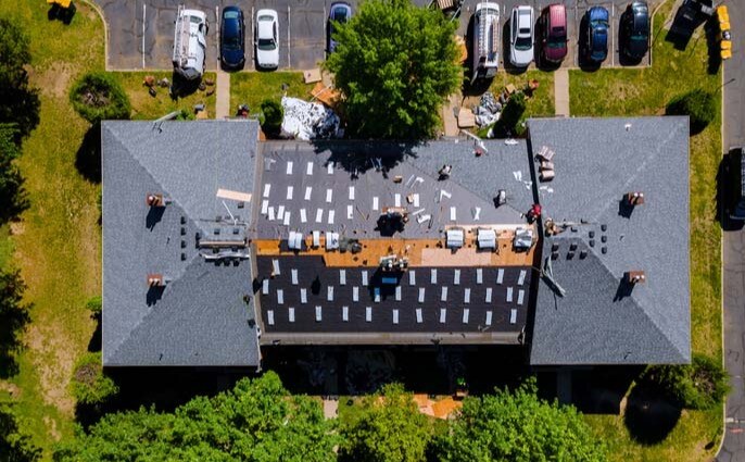 apartment building roof repair in progress