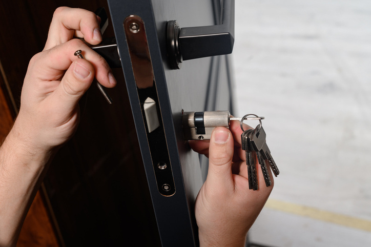 commercial locksmith installing lock