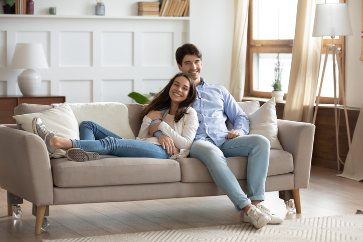 happy tenants sitting on couch